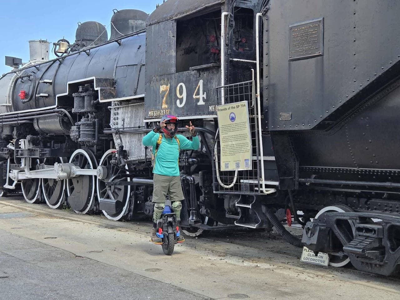 Anthony P. riding his EUC in front of historic SP 794 locomotive